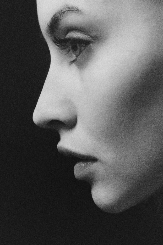 Close-up side profile of a woman with healthy, natural-looking skin